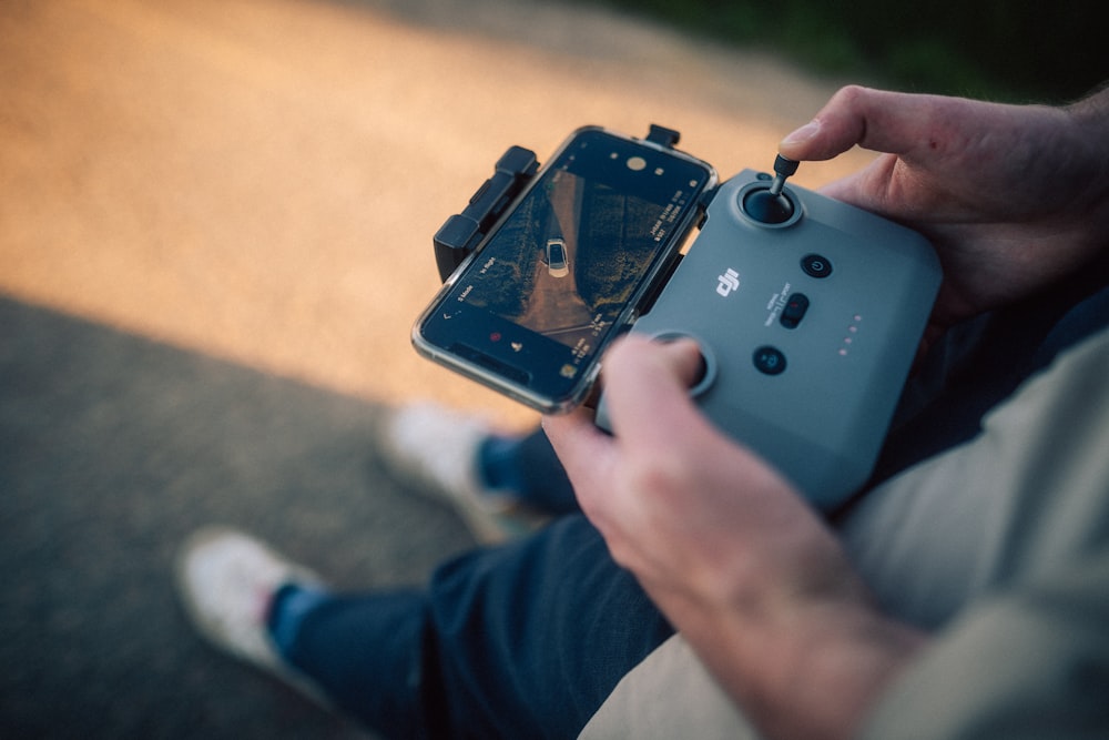 person holding black dslr camera