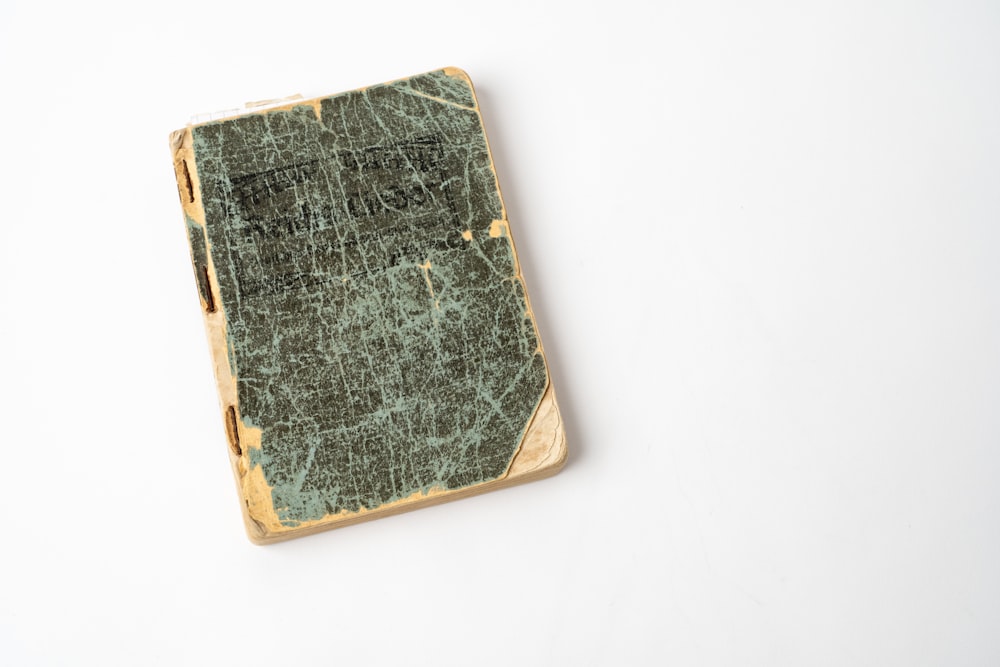 black and brown book on white table