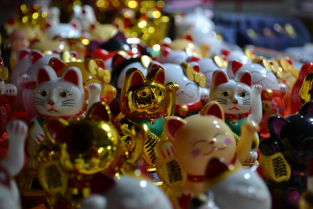 white and gold ceramic cat figurines