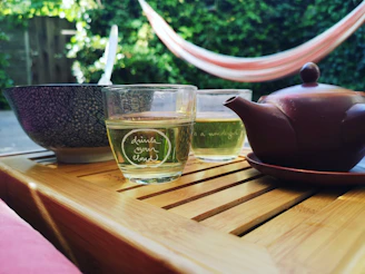 A serene morning scene with a cup of herbal wellness tea on a wooden table.