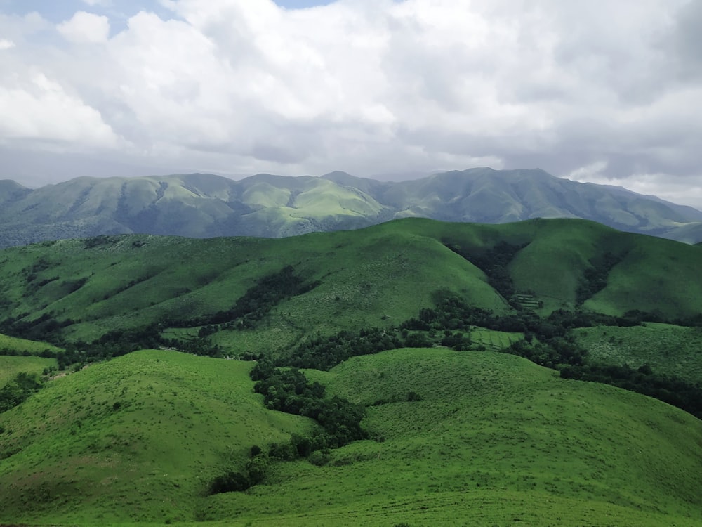 green mountains under white clouds during daytime