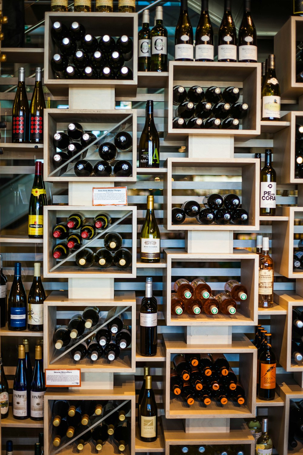 wine bottles on brown wooden shelf