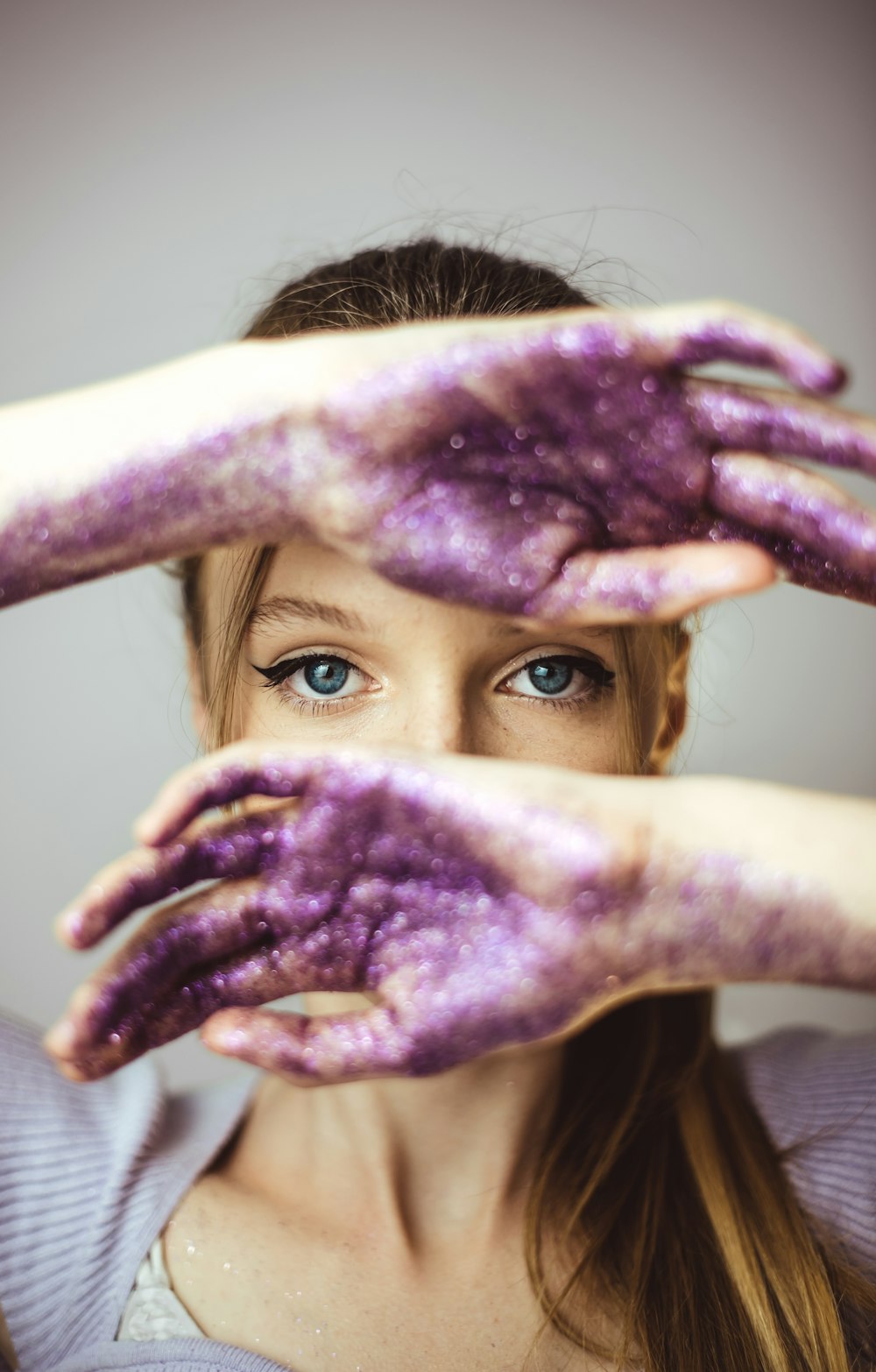 woman with brown hair covering her face