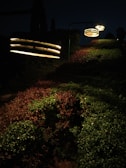 Evening scene showing garden lights highlighting the green areas enlivened by smart irrigation.