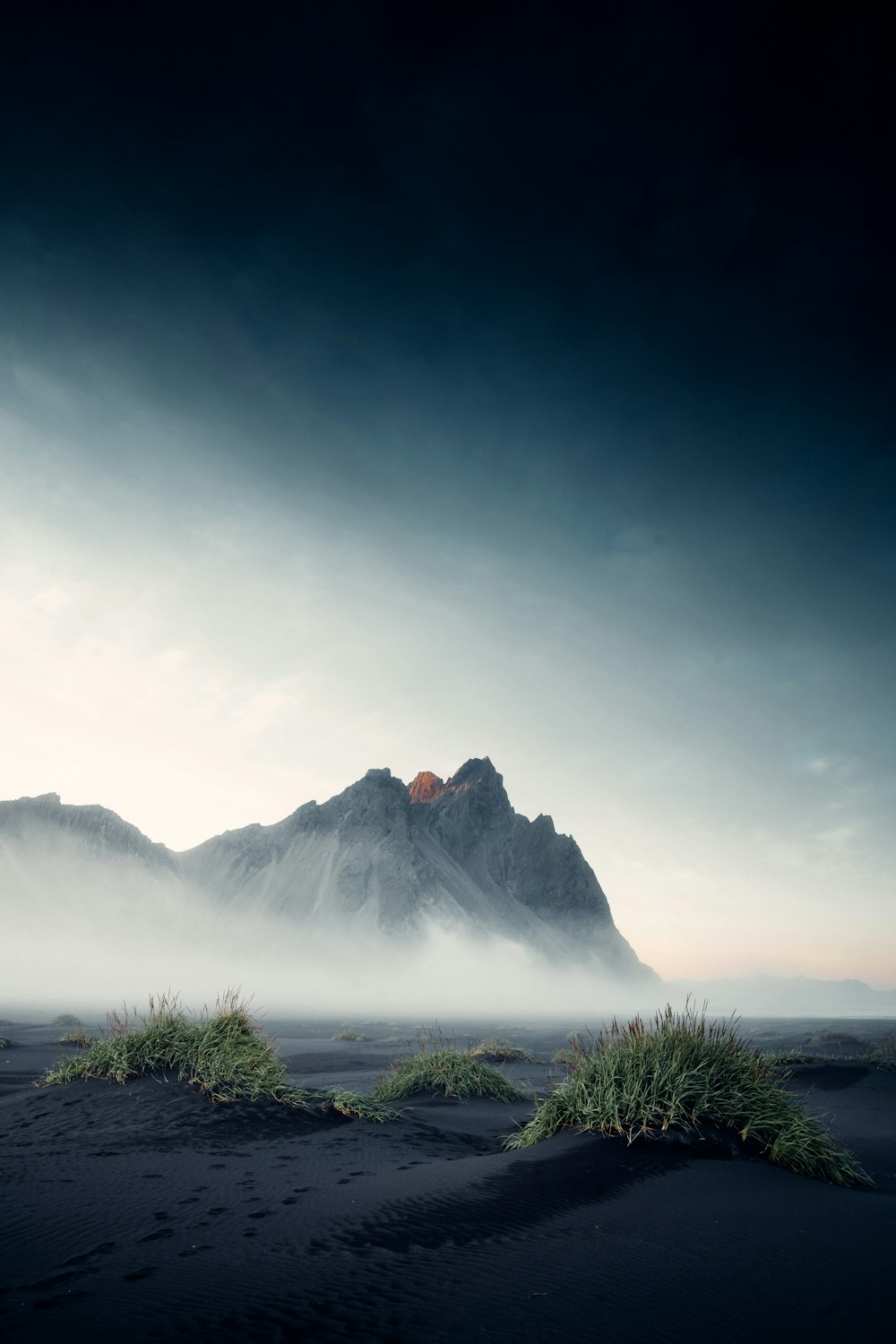 snow covered mountain under cloudy sky during daytime