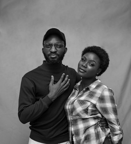 A black and white portrait of a couple sharing a quiet moment.