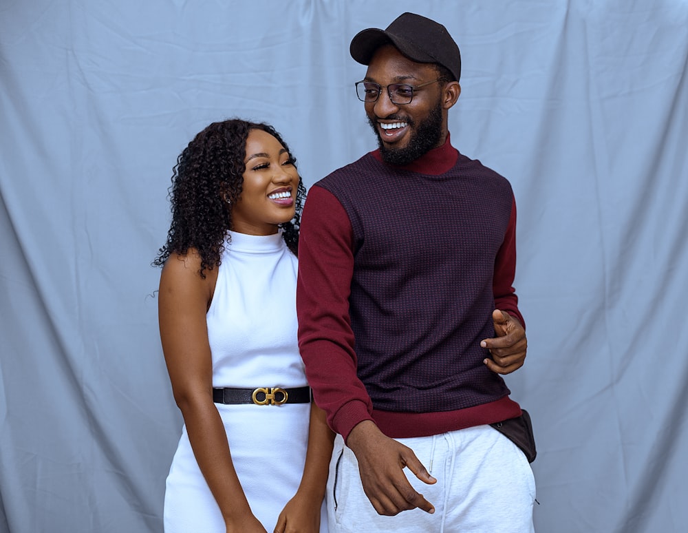 man in red crew neck long sleeve shirt beside woman in white crew neck shirt