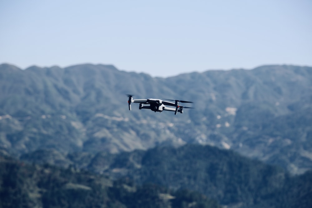 a small plane flying over a mountain range