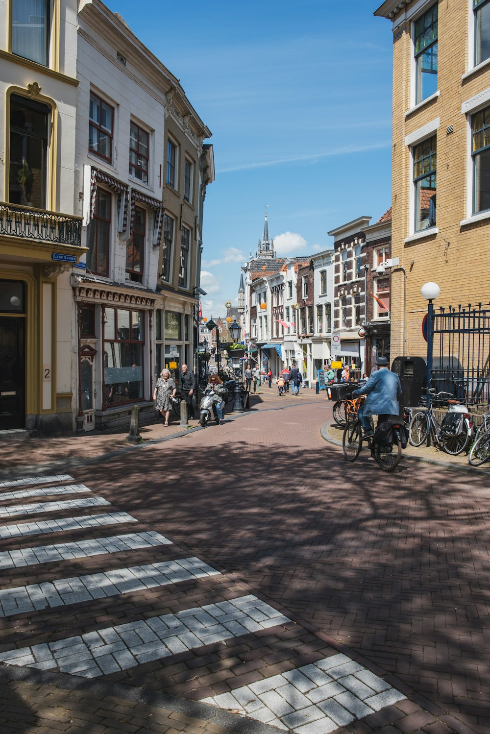 people riding on bicycle on street during daytime