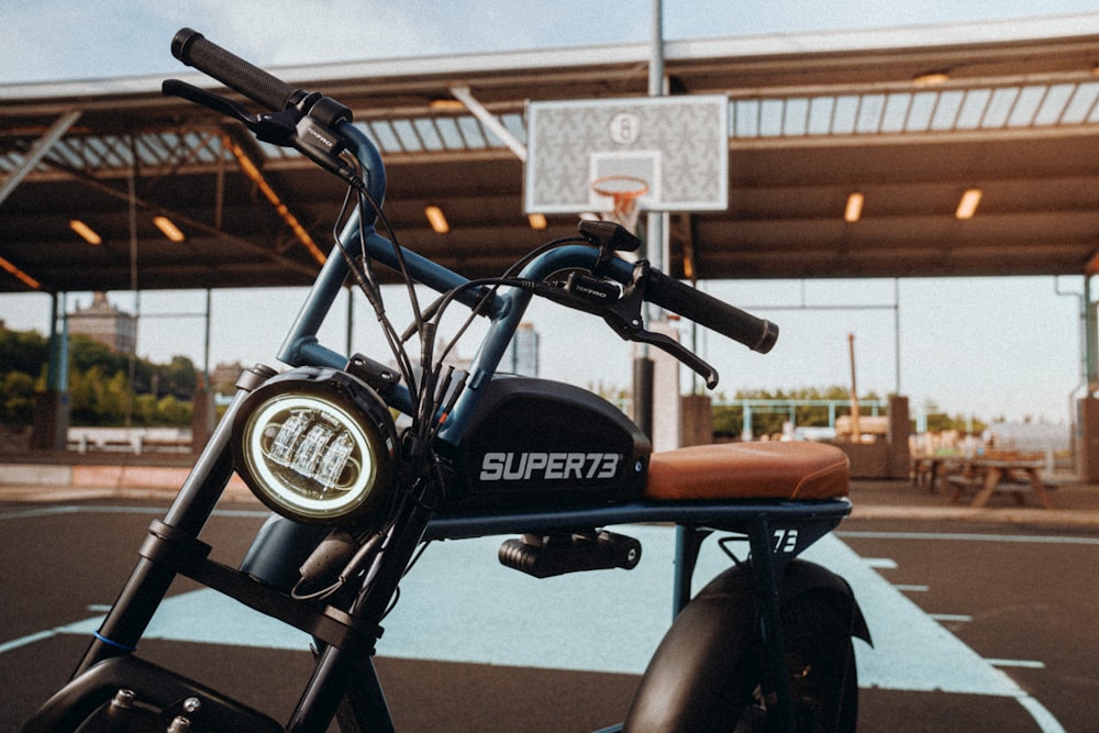 black and brown motorcycle parked beside brown car