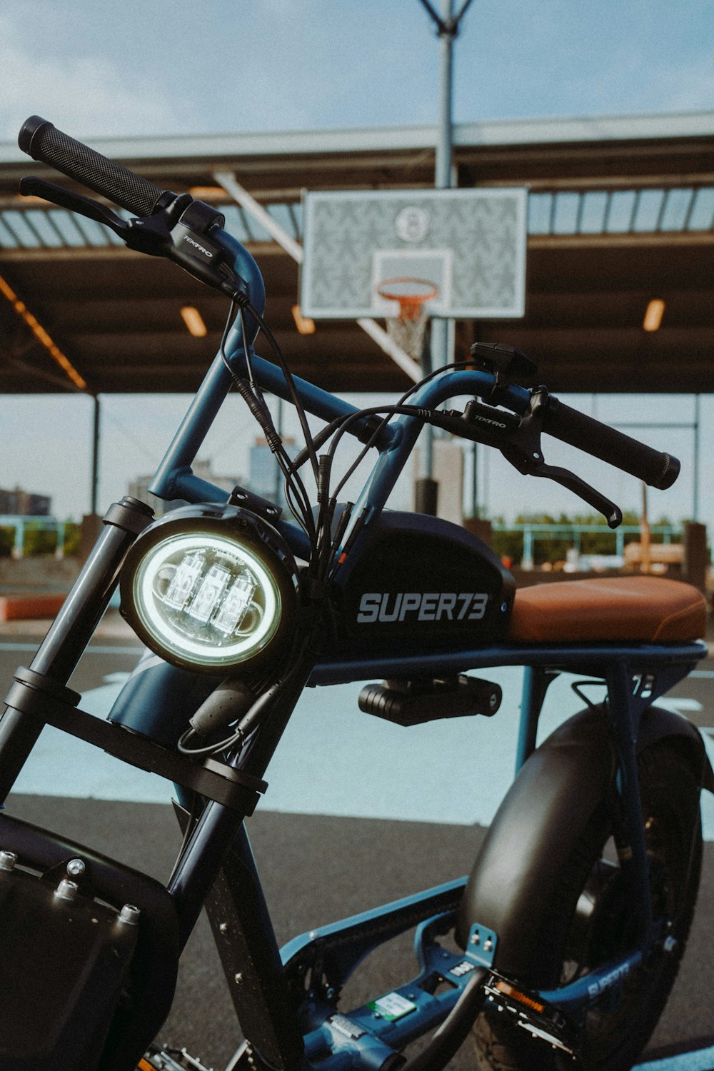 black motorcycle in front of brown building during daytime