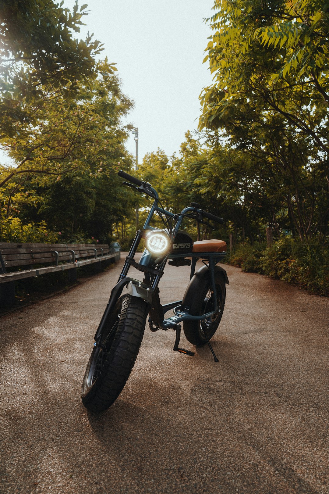 black motorcycle parked on brown dirt road during daytime