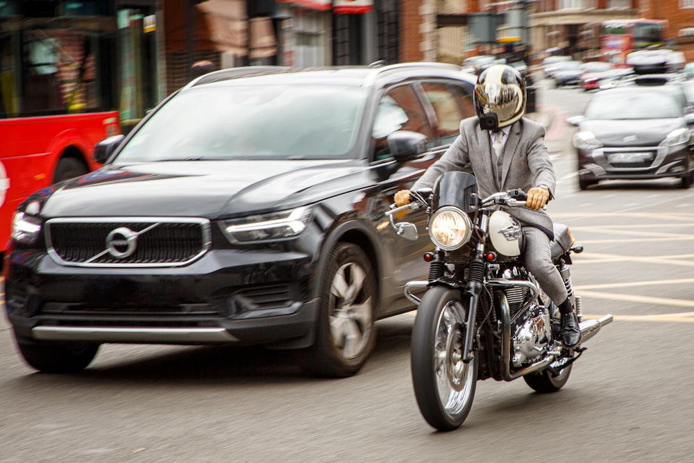 man in gray jacket riding motorcycle