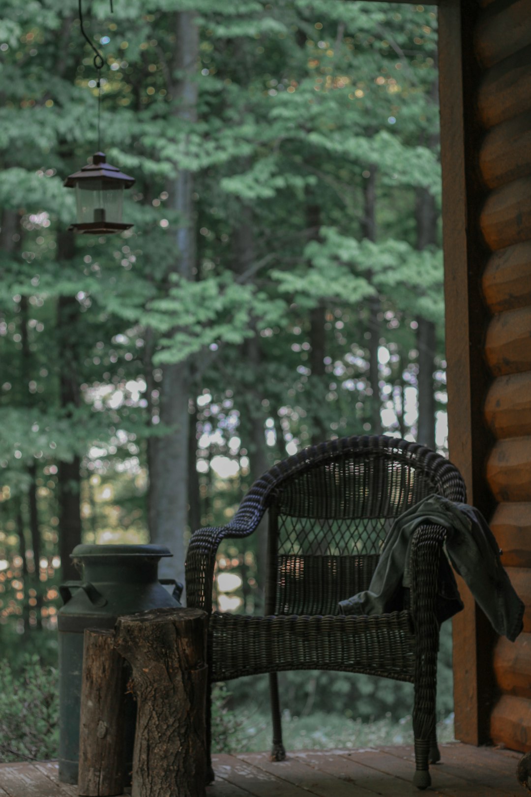 brown wicker armchair near green trees during daytime