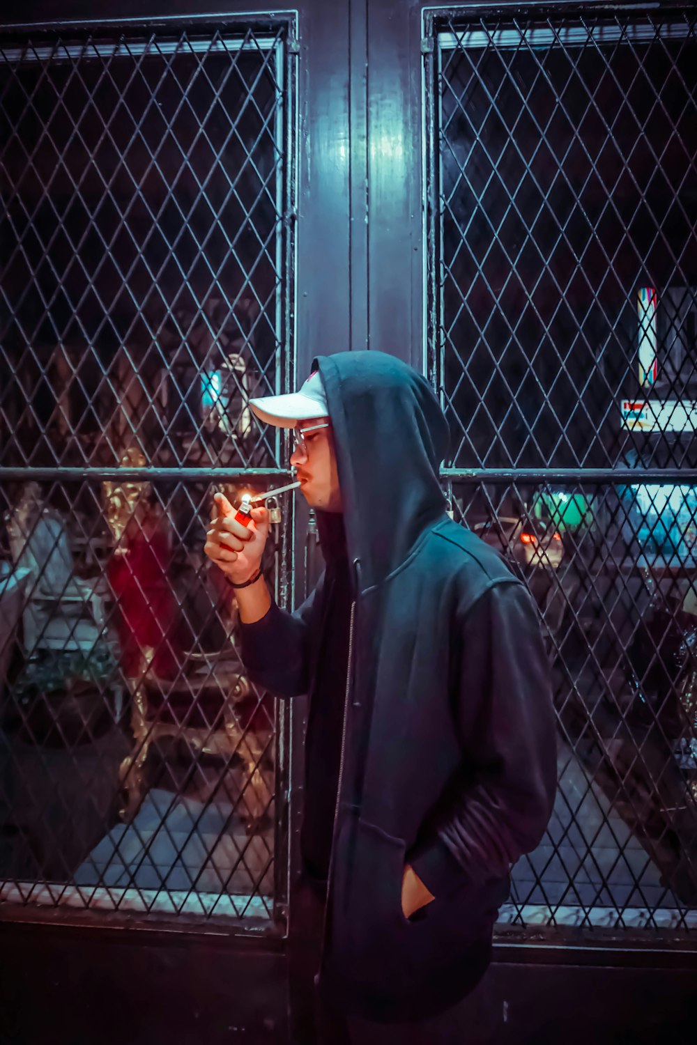 man in black hoodie smoking cigarette