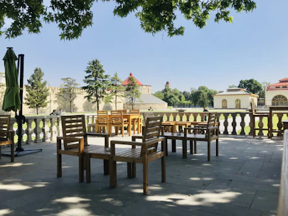 Peaceful outdoor seating area surrounded by lush greenery in Bademli.