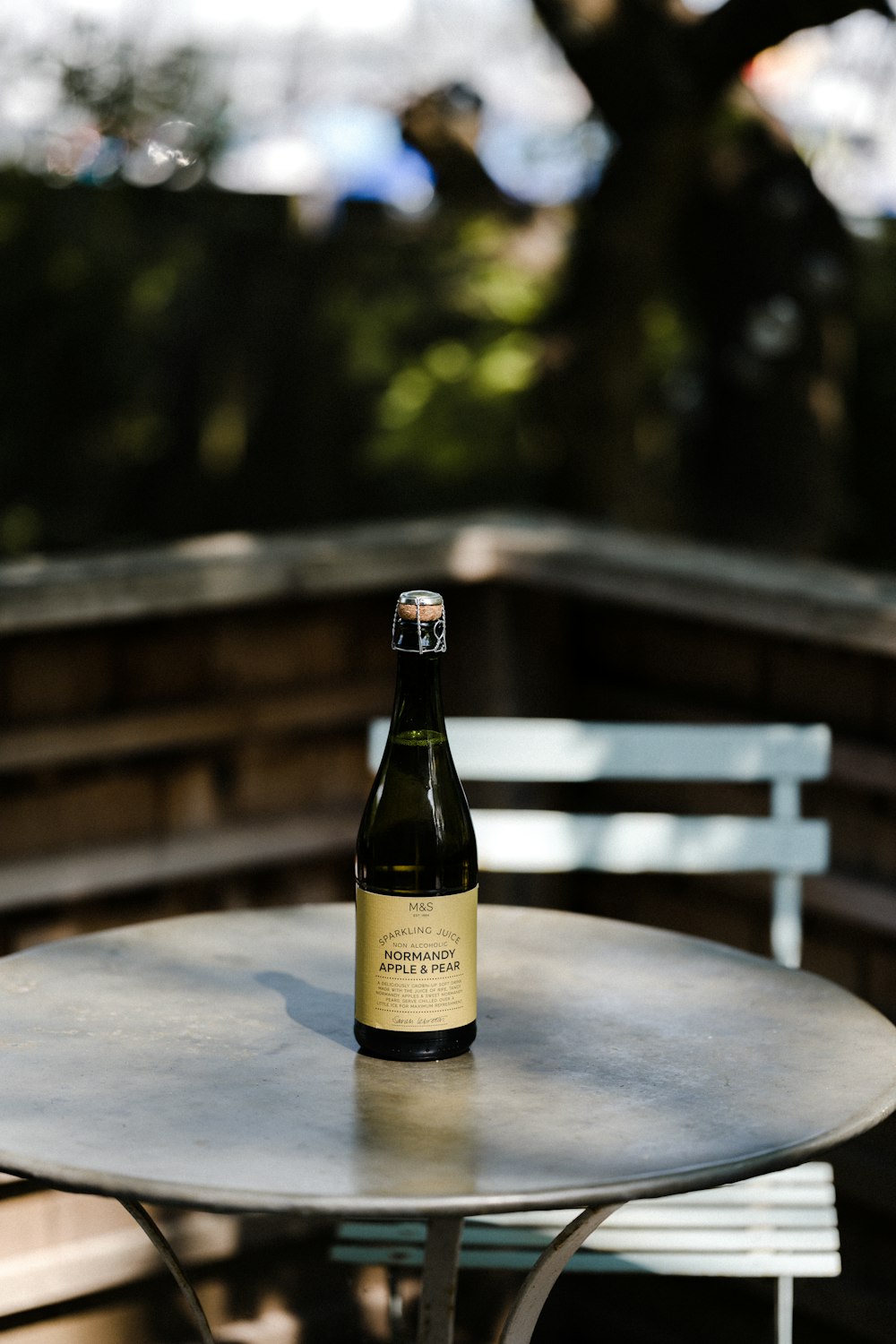 brown glass bottle on brown wooden table