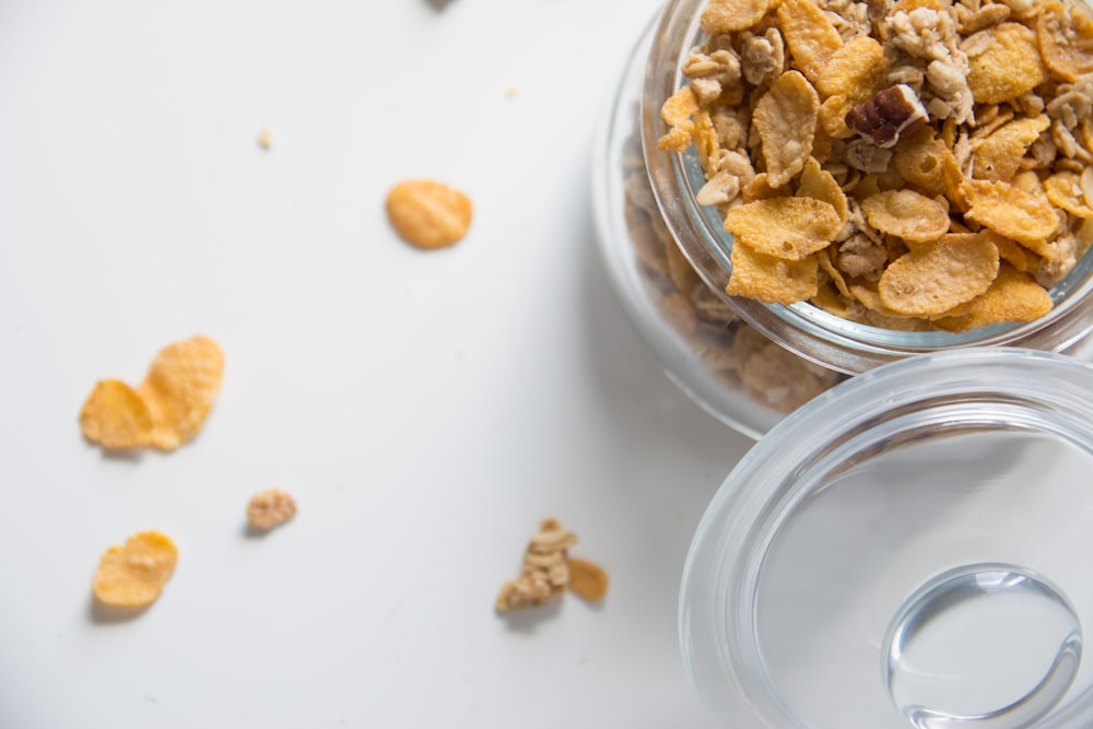 brown peanuts on clear glass bowl