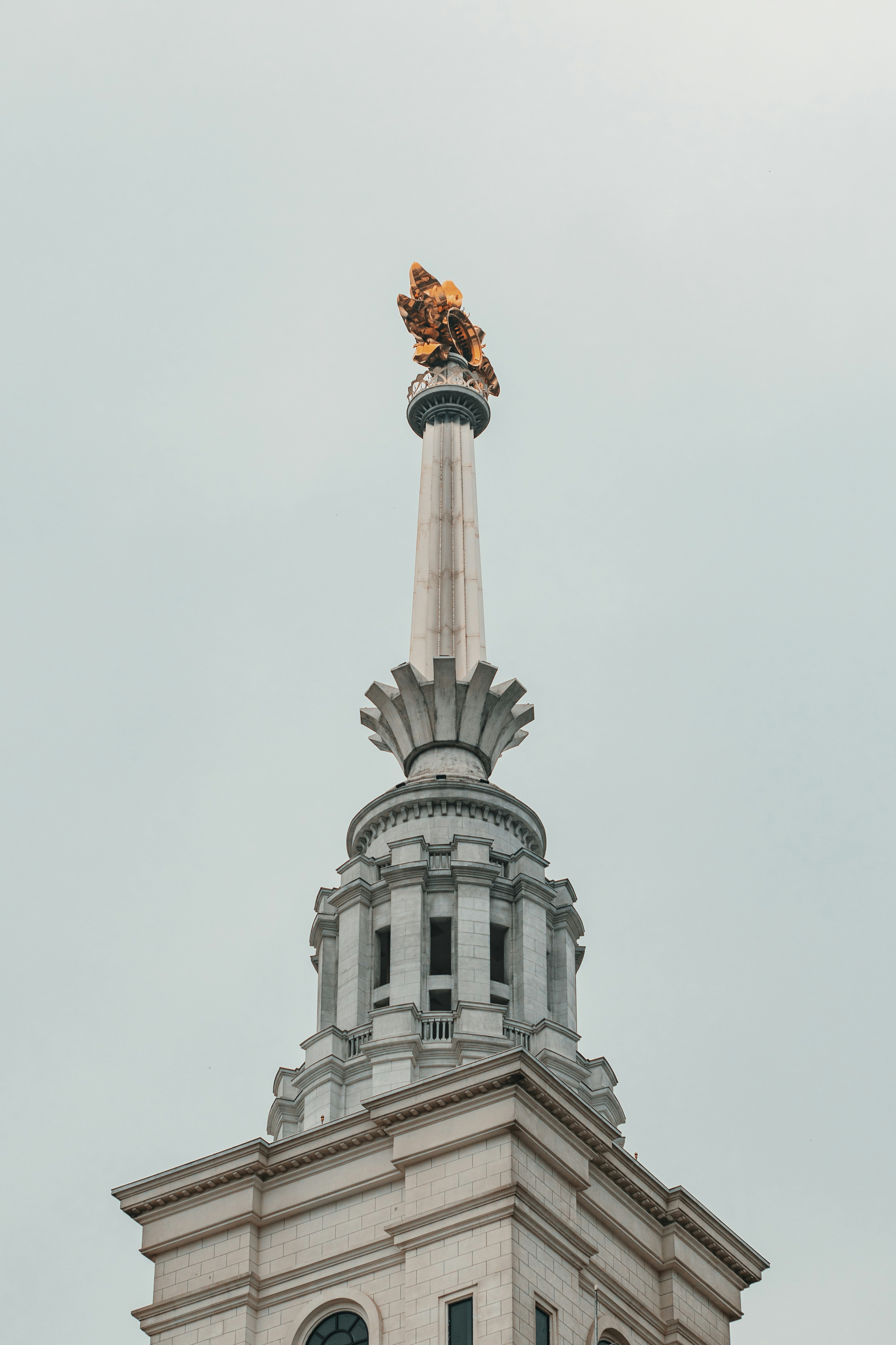 white concrete tower under white sky during daytime