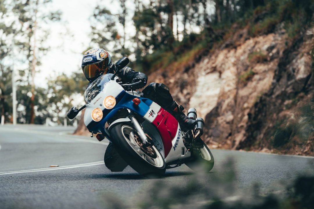 man in red and white motorcycle suit riding on motorcycle