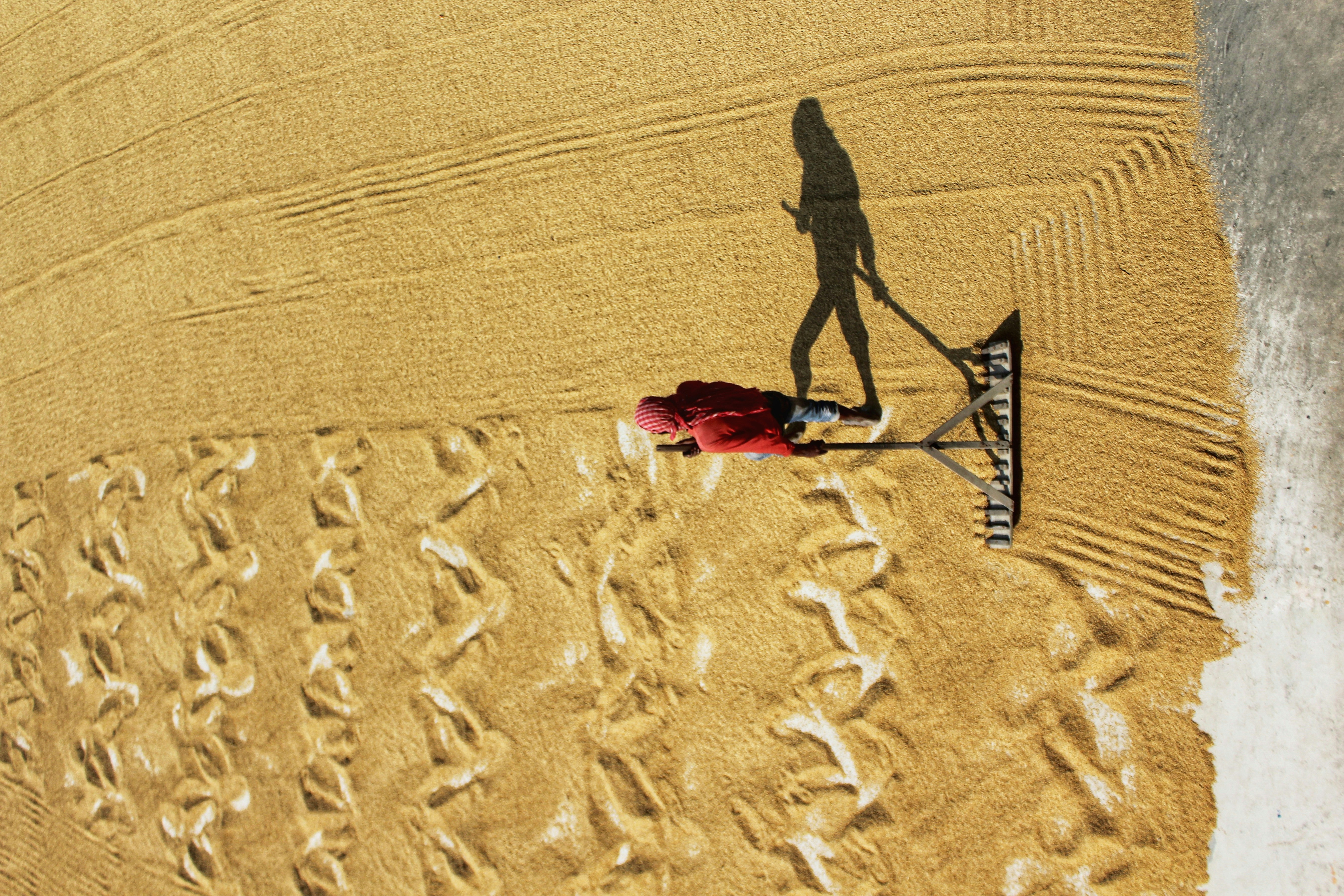 person walking on sand during daytime
