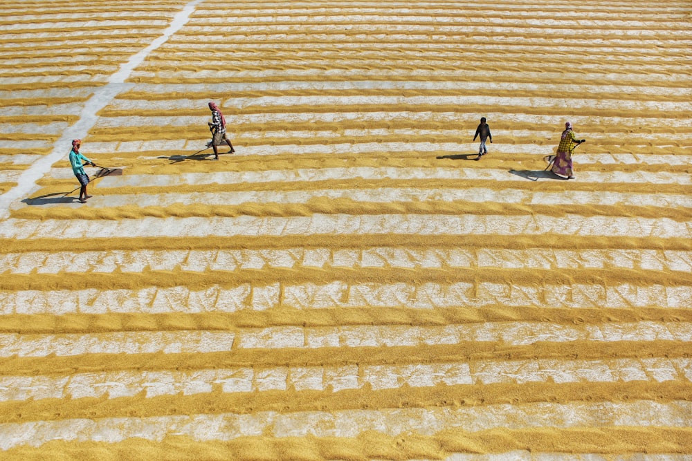 man in black shirt and black pants walking on yellow and white stripe floor