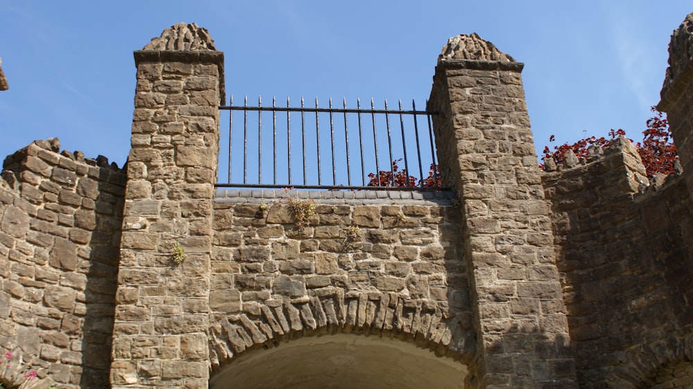 brown brick building with red metal gate under blue sky during daytime