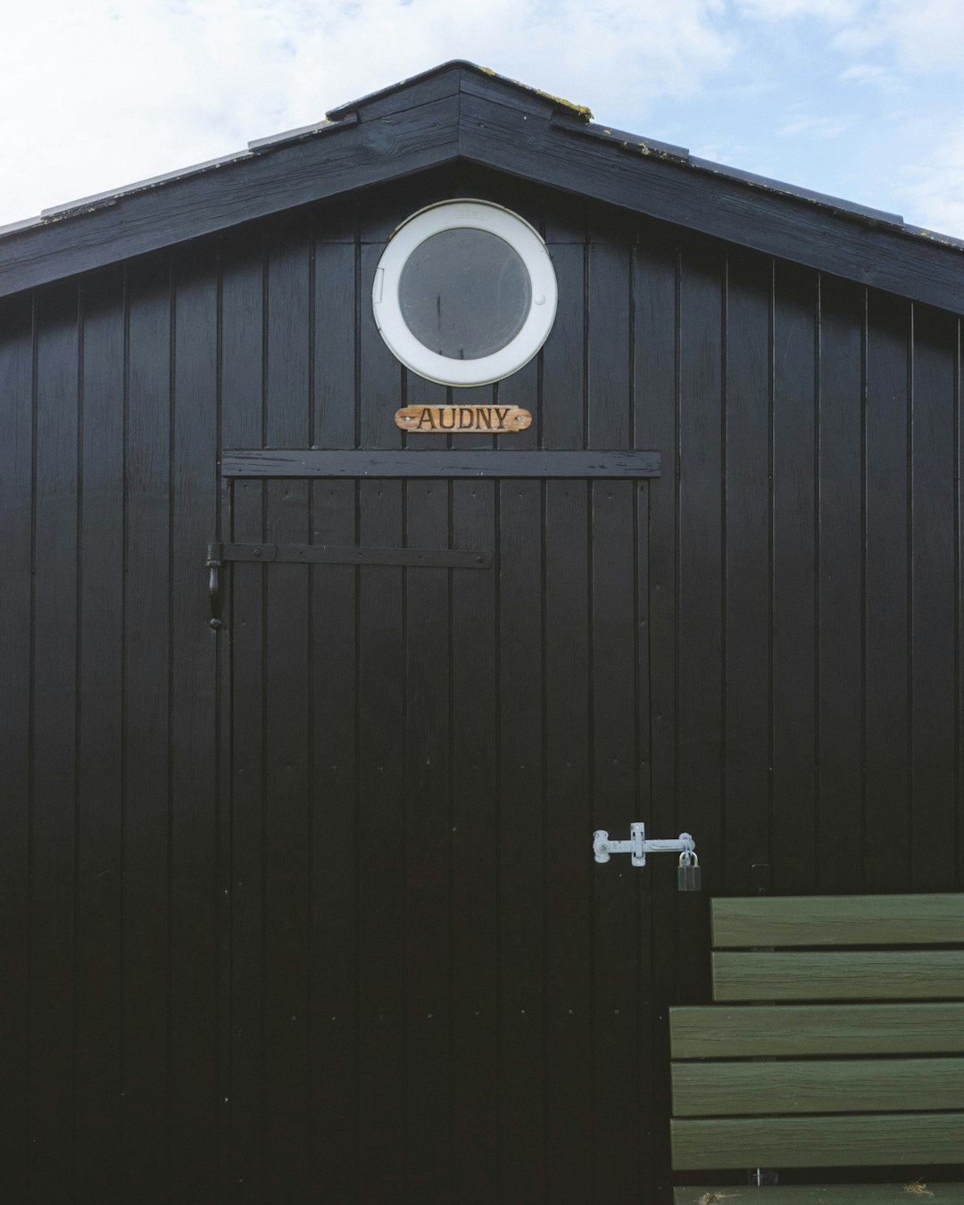 black wooden house under white clouds during daytime