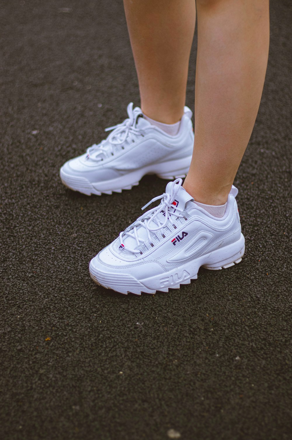 Person wearing white nike athletic shoes photo – Free Fila sneakers Image  on Unsplash