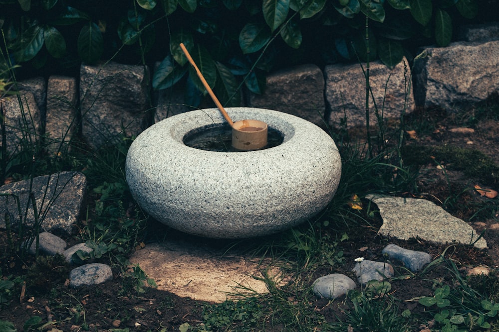 white concrete round outdoor fountain