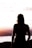 woman in black tank top standing on beach during sunset
