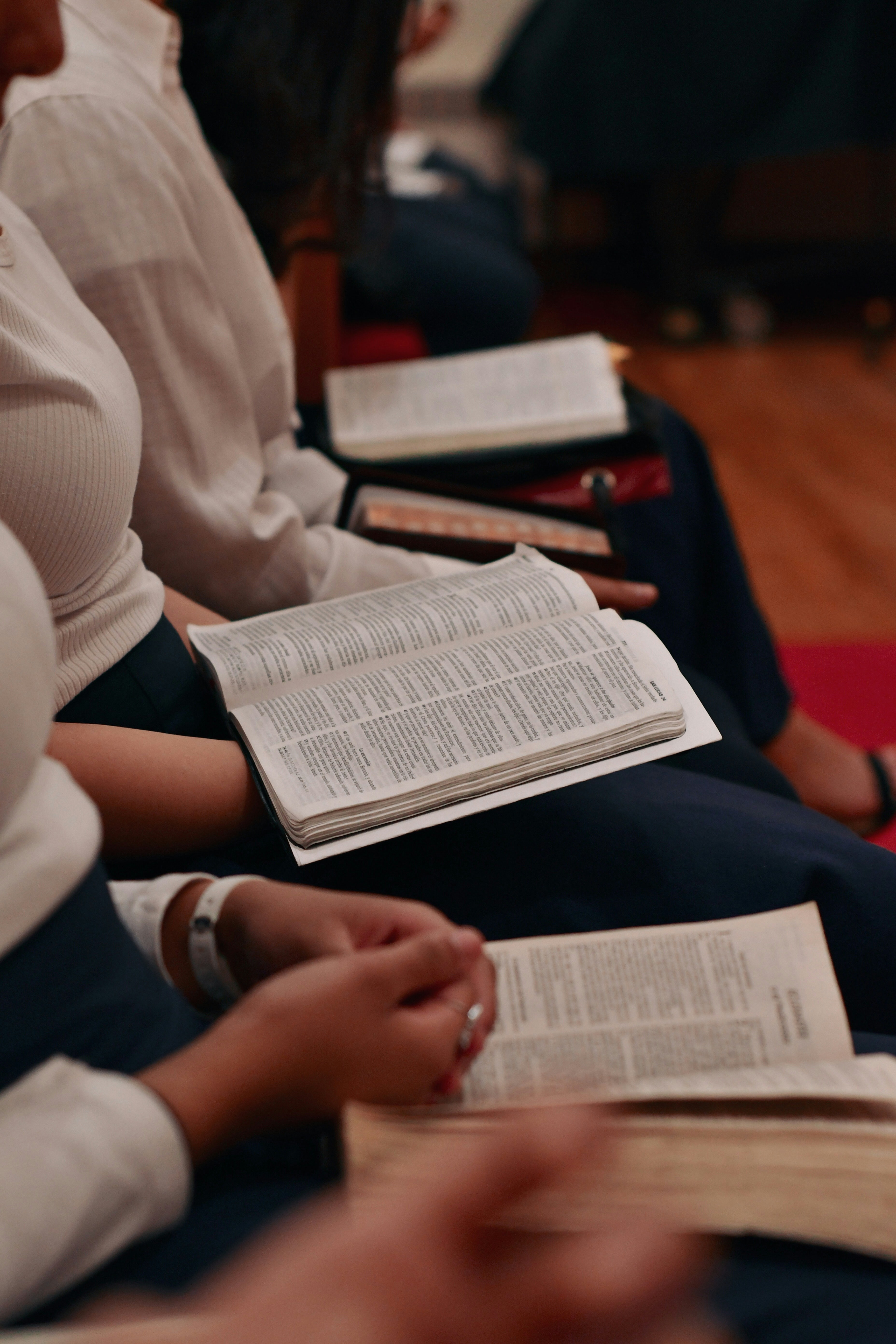 person in white long sleeve shirt reading book