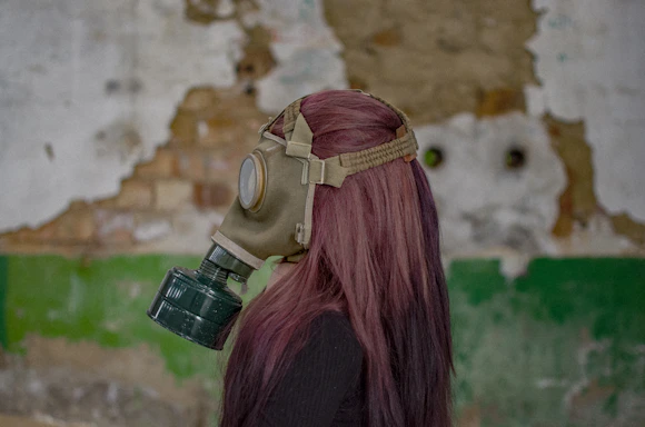 woman in red hair wearing gas mask