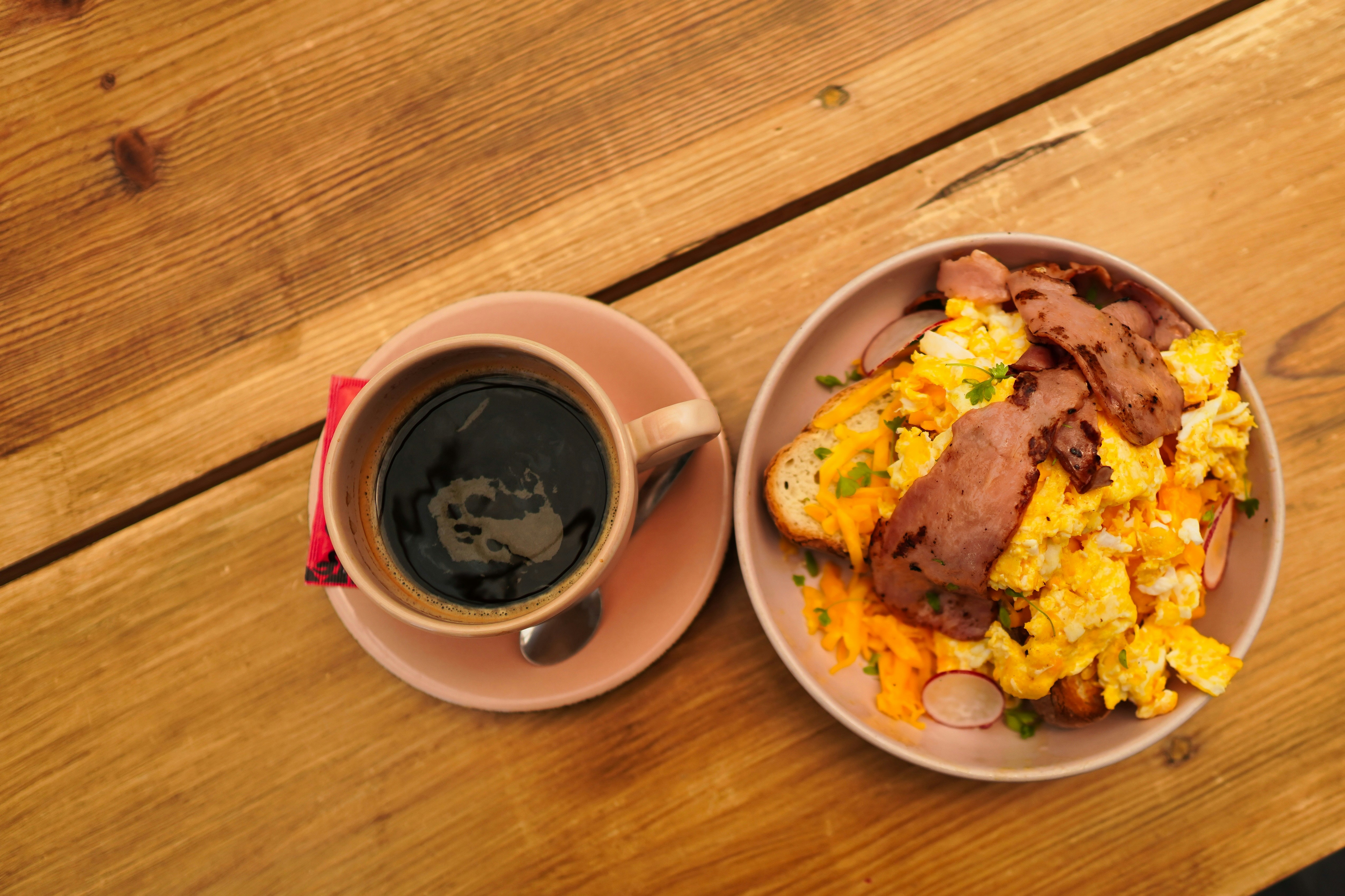 Scrambled eggs bowl with black coffee