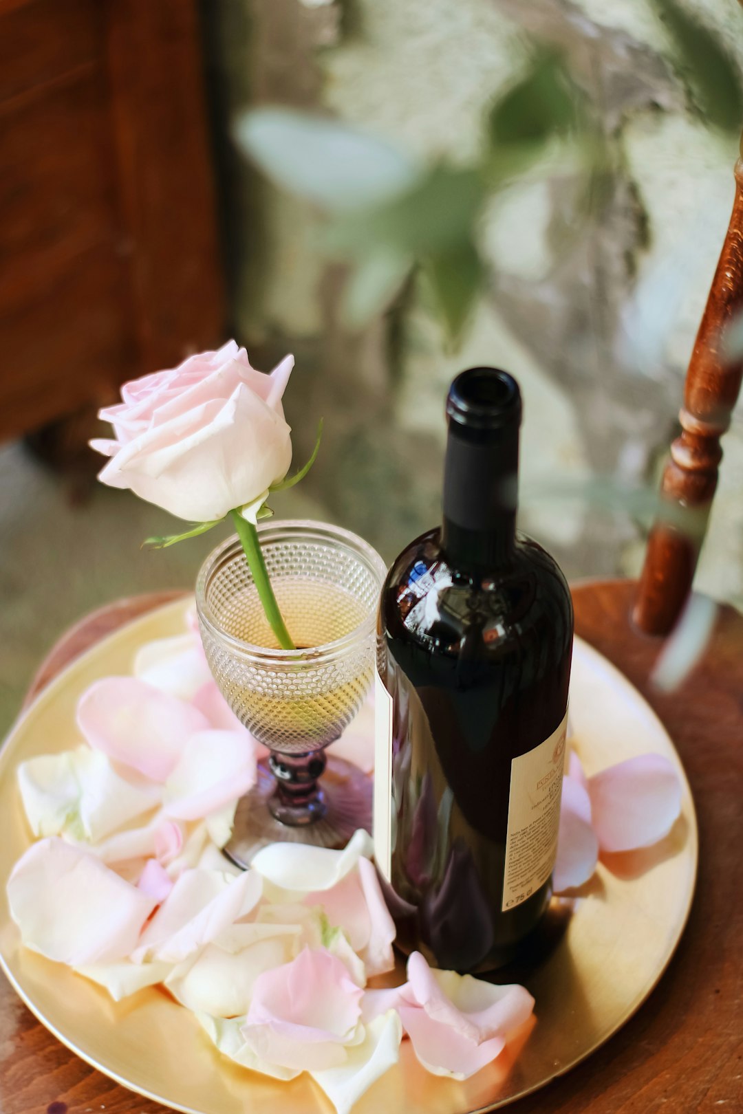 black glass bottle beside white ceramic bowl