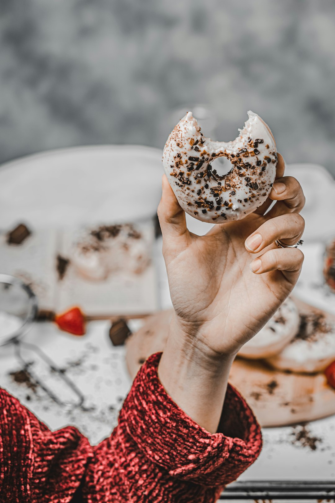 person holding white and brown doughnut