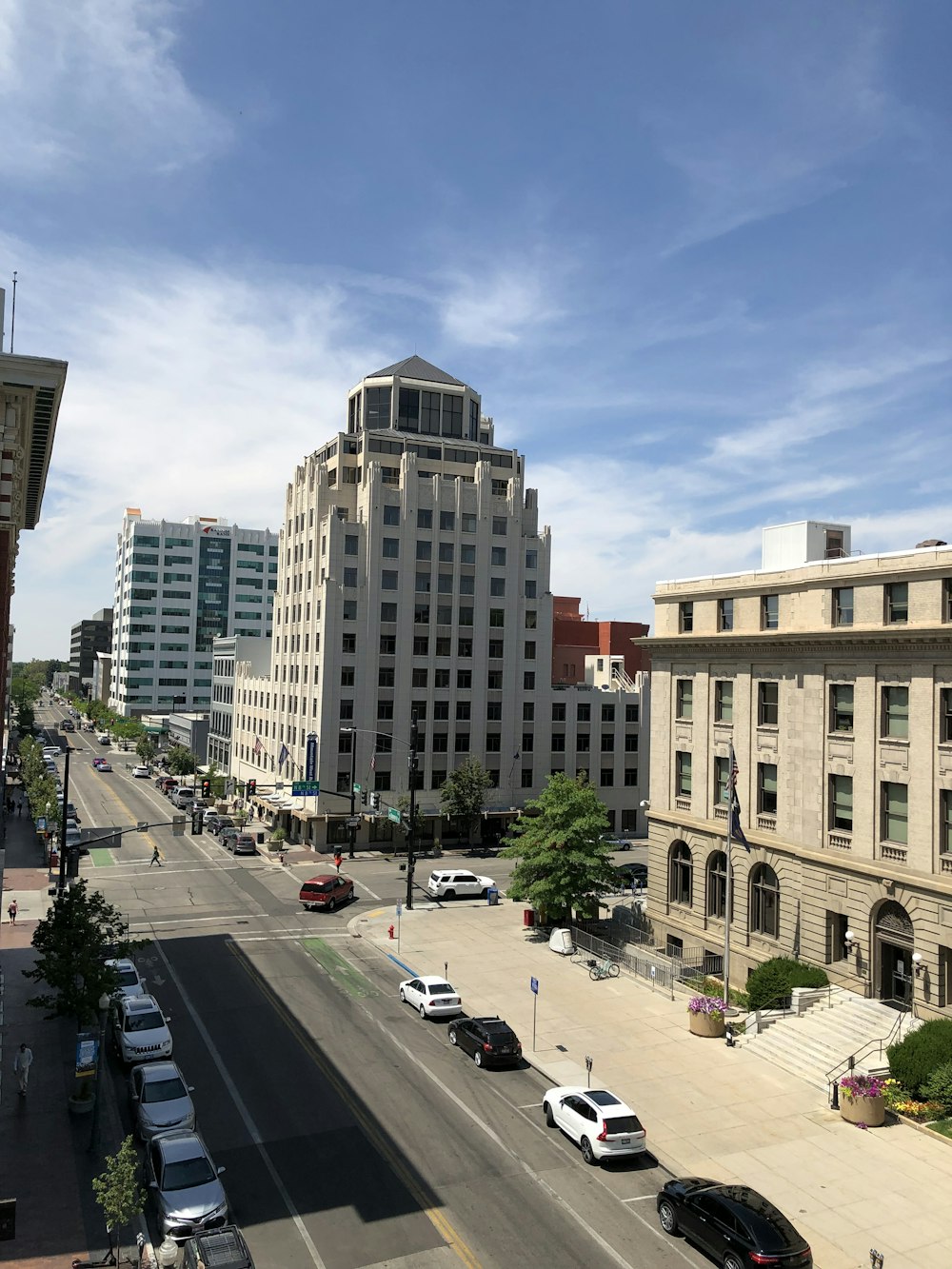 cars parked on parking lot near brown concrete building during daytime