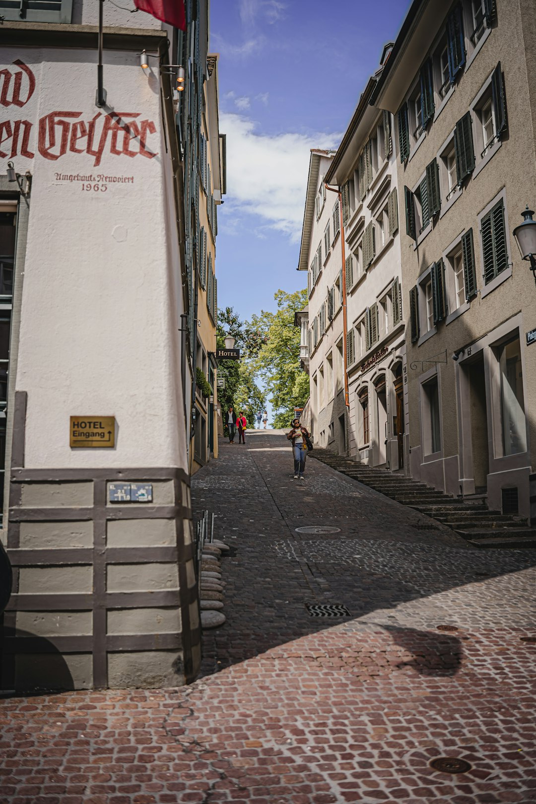 woman in black jacket walking on sidewalk during daytime