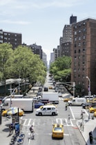 cars on road near high rise buildings during daytime