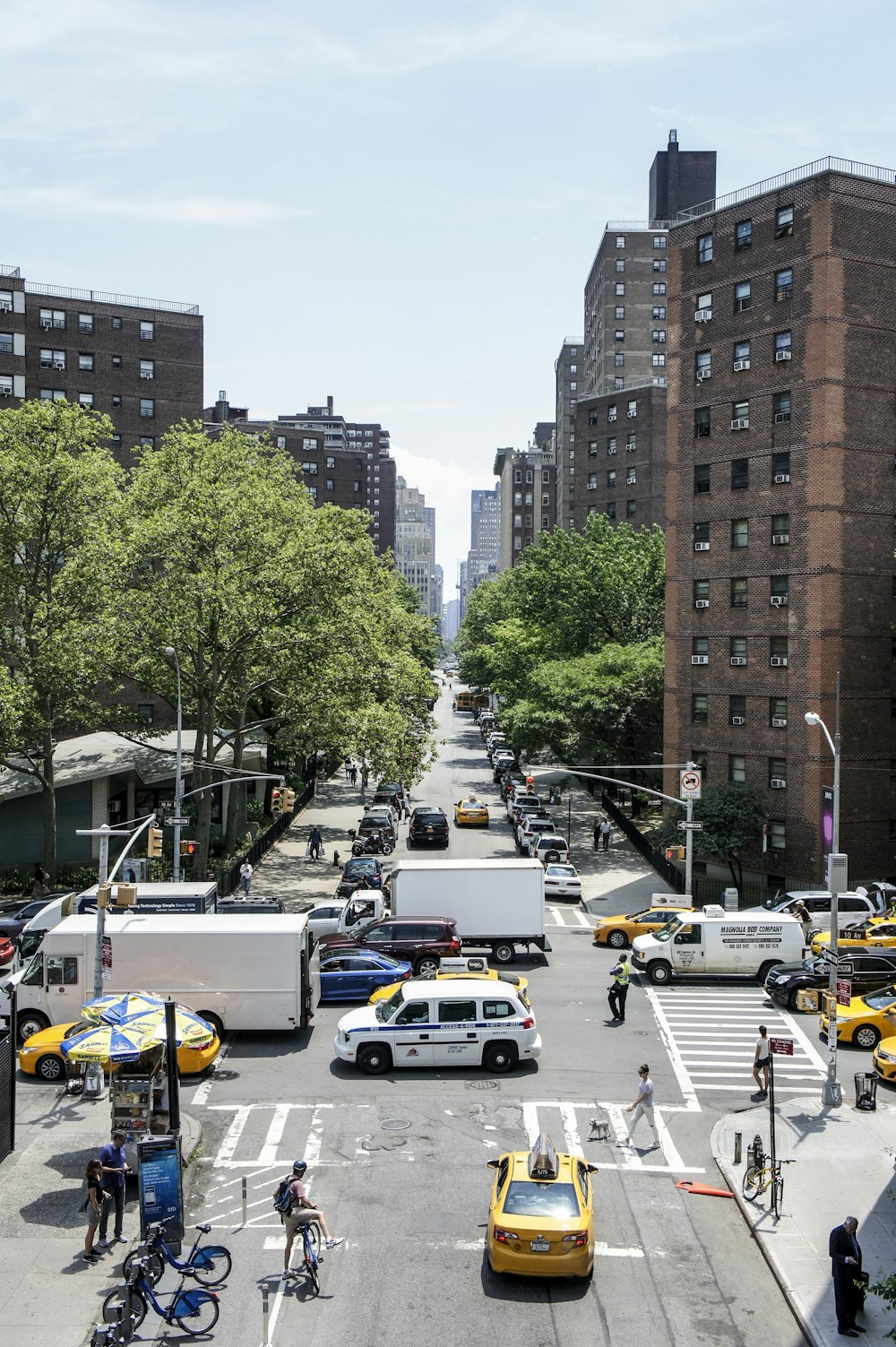 cars on road near high rise buildings during daytime