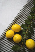 Bright, cheerful lemons arranged around a notebook and pen, symbolizing fresh starts