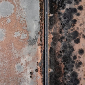 an aerial view of a road and a field