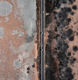 an aerial view of a road and a field