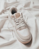 white adidas low top sneaker