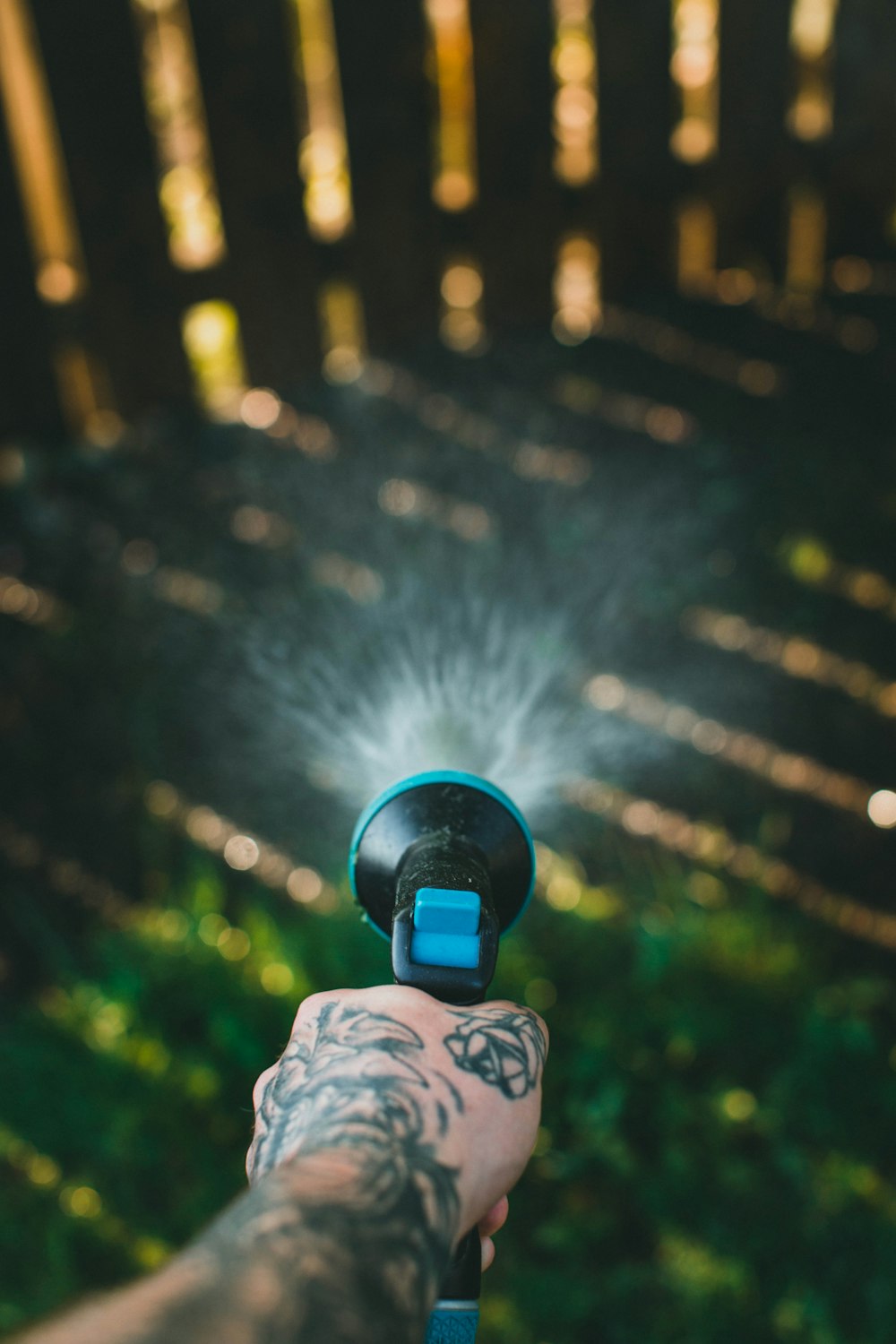 a hand holding a water gun with a sprinkle of water coming out of