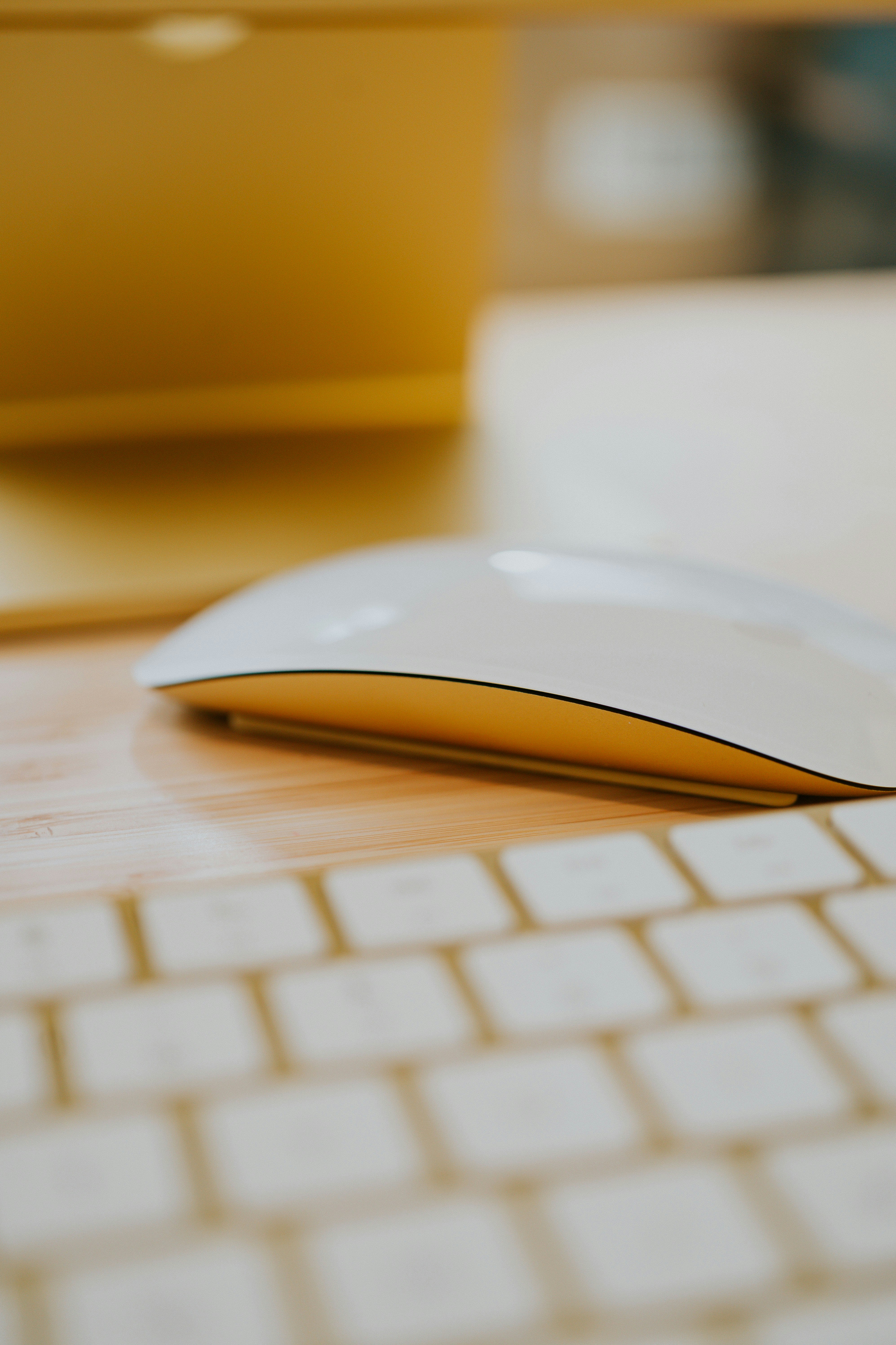 Yellow Apple MAgic Mouse on a desk in home office with iMac 24\