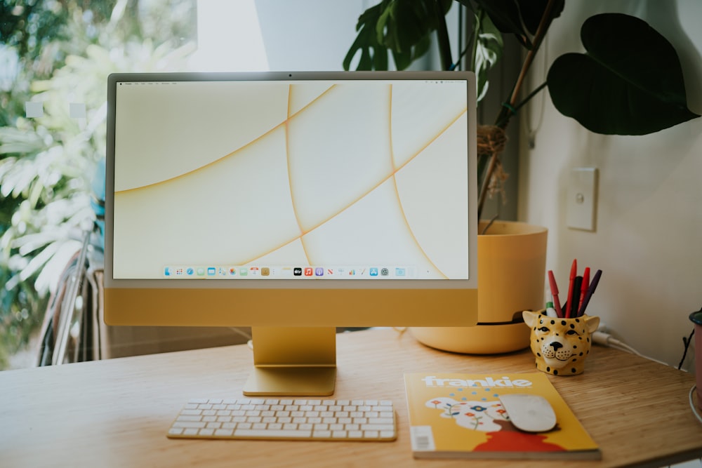 silver imac on brown wooden table