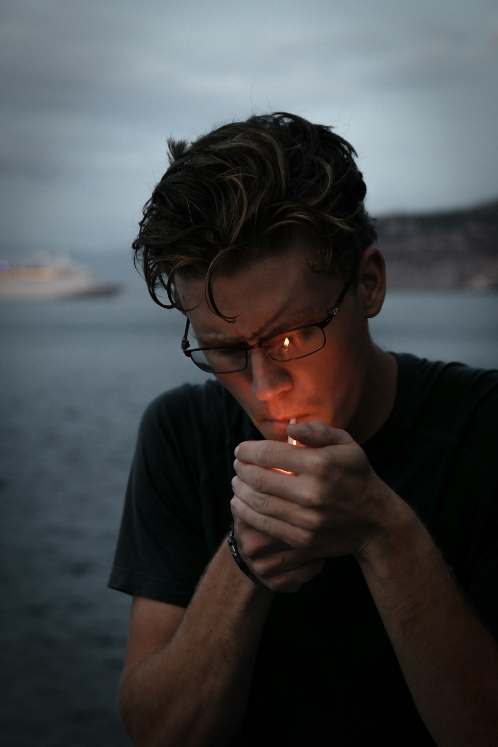 a man holding a lit candle in his hands