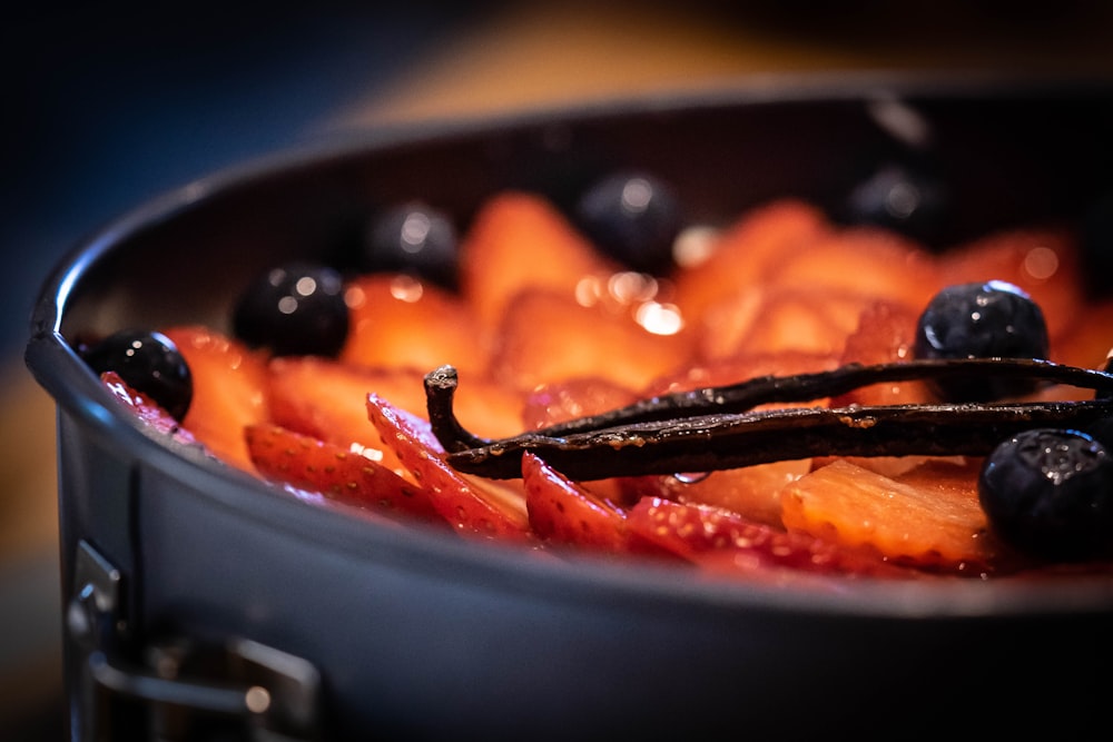 sliced tomato on black ceramic bowl