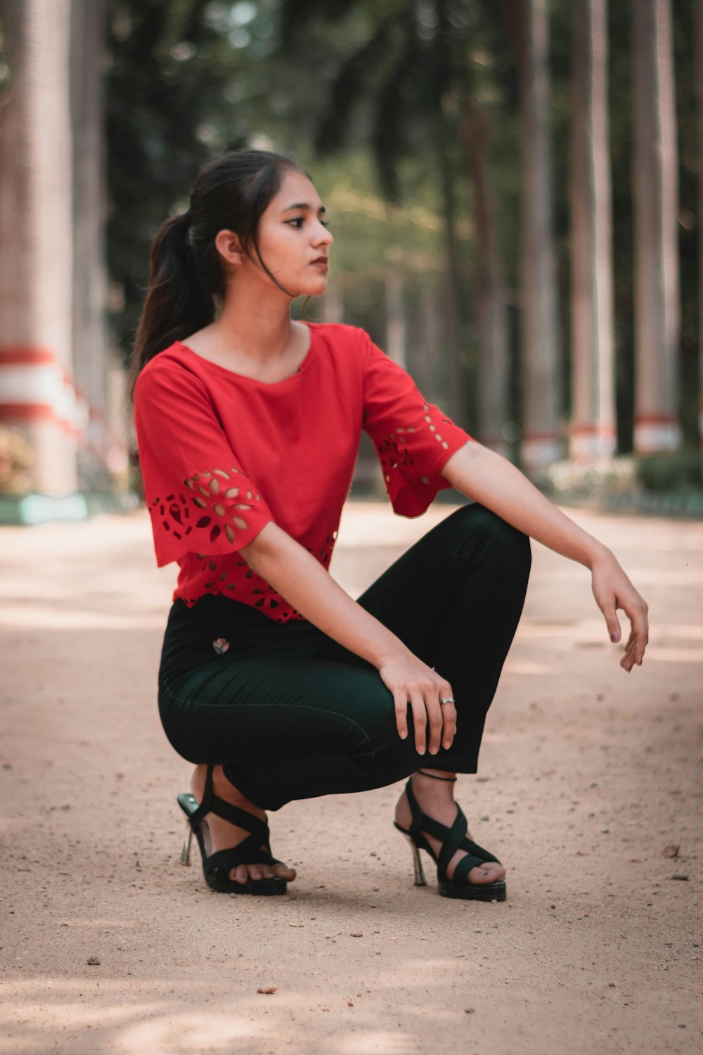 a woman in a red shirt and black pants